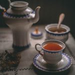 British Tea Set - white ceramic teapot beside white ceramic teacup on saucer