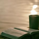 Puerh Tea Wedge - green ceramic mug beside book