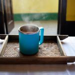 Bamboo Tea Tray - a blue cup on a wooden surface