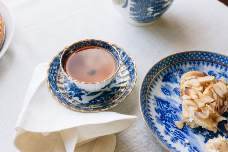 Ceramic Teapot Design - cup filled with brown liquid near plate