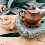 Yixing Teapot Clay - brown clay teapot on heated stone