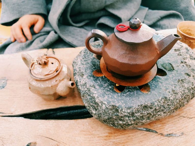 Yixing Teapot Clay - brown clay teapot on heated stone