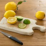 Lemon Balm Tea Lemon - sliced lemon beside knife on brown wooden chopping board