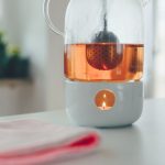 White Tea Steeper - tealight candle with white holder on table