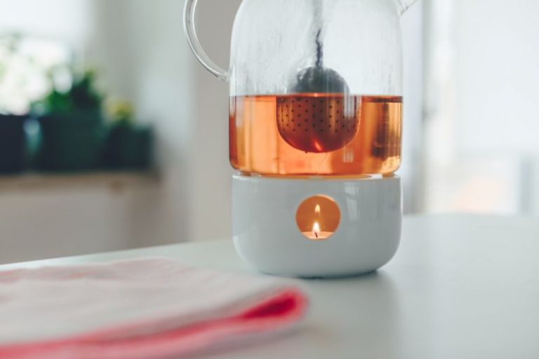 White Tea Steeper - tealight candle with white holder on table