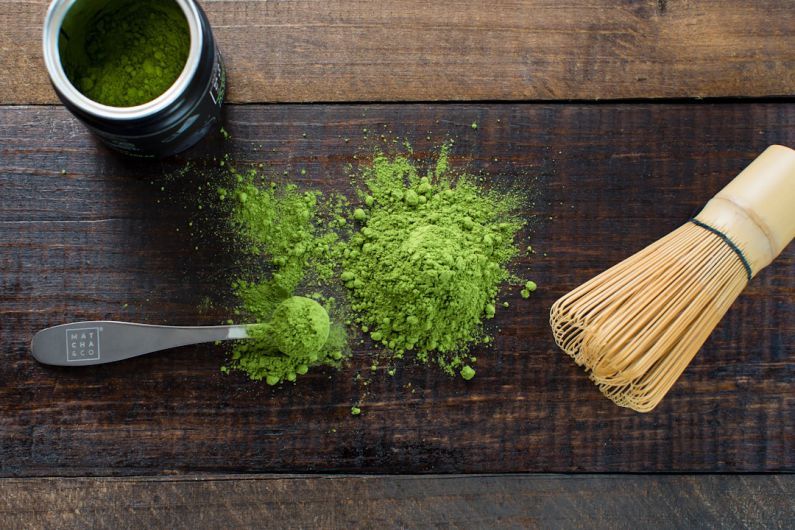 Matcha Tea Chasen - green powder and spoon on board