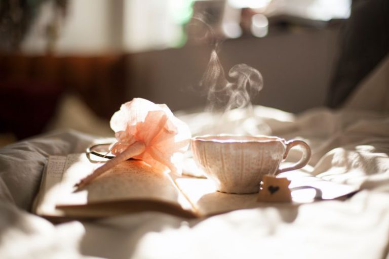 Sencha Tea Leaves - teacup on book beside pink flower decor