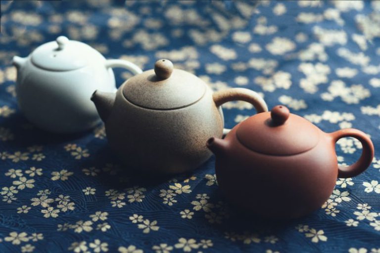 Teapot Pouring Tea - three assorted-color teapots