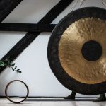 Gong Fu Cha Set - round black and brown gong beside potted green leafed palnt