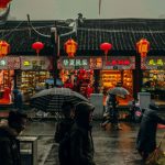 China Tea Culture - person carrying umbrellas