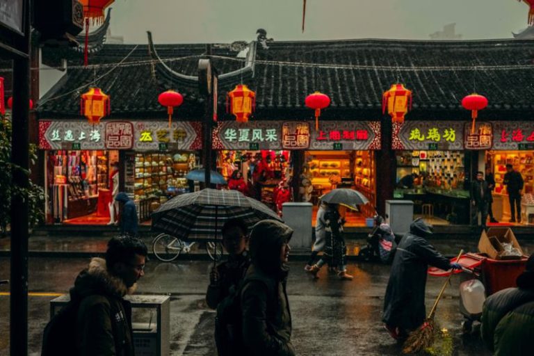 China Tea Culture - person carrying umbrellas