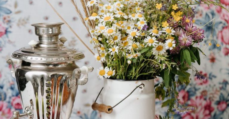 Russia Tea Samovar - Person Holding White and Yellow Flowers in Vase